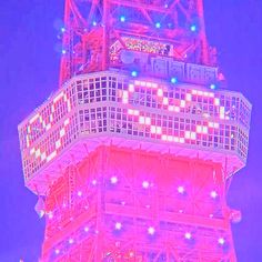 the eiffel tower is lit up in pink