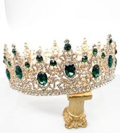 This beautiful vintage deluxe costume accessory includes one sparkling full round queen, king crown featuring a gold metal base with green oval crystal accents with round clear crystal high points and a fully lined crystal bottom rim. Perfect for plays and projects, cosplay, royalty, St. Patrick's Day, Mardi Gras, Halloween, theme parties and more. Other royal costumes and accessories are sold separately on our page – subject to availability. One size fits most Smaller Adults and Teens - may fit Royal Costumes, Quince Crowns, Medieval Crown, Royal Costume, Prom Birthday, Head Crown, Bride Crown, Crown For Women, Silver Tiara