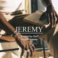 a man sitting in a chair holding an open book with the words jeremy written on it