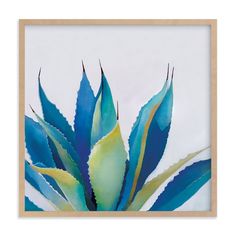 a painting of blue and green leaves in a wooden frame