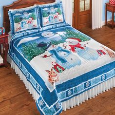 a bed covered in blue and white snowman comforter with matching pillow shampoos