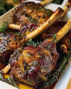 meat and vegetables on a white plate with herbs in the middle, ready to be eaten