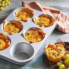 an advertisement for large muffin pans on a table with grapes and other food items