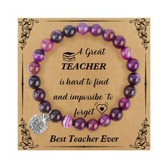 a purple bracelet with a heart charm on it and the words, a great teacher is hard to find and impossible to forget