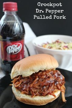 a pulled pork sandwich on a black plate