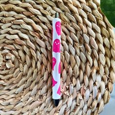 a pink and white pen sitting on top of a wicker basket