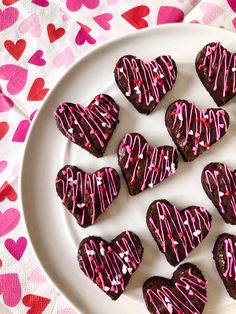 heart shaped chocolates with pink icing on a white plate