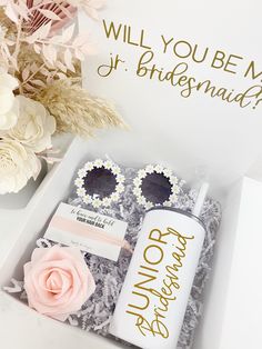 the bridesmaid gift box is filled with pink flowers and personalized gifts for her