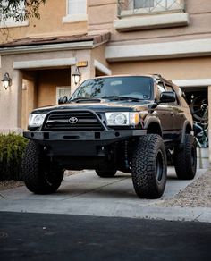 a black truck parked in front of a house