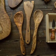 wooden spoons and other kitchen utensils laid out on a table