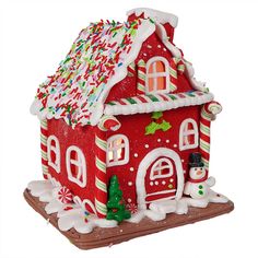 a gingerbread house decorated with candy canes and icing