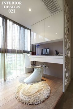 a white chair sitting on top of a wooden floor in front of a computer desk