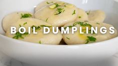 some dumplings are in a white bowl on a marble counter top with the words boil dumpings