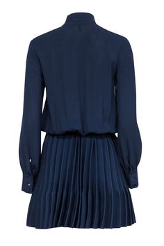 Get ready to turn heads at your next cocktail party with this chic Maje dress! You'll be twirling across the floor in style with precious pleating on the ribbed knit skirt. A playful neck tie completes the look of this gorgeous navy number. Style with neutral pointed-toe pumps for a polished look. Size 4 (Maje 1) Upper 97% Polyester, 3% Elastane Lower 97% Polyamide, 3% Elastane Pullover V-neck w/ neck tie Buttoned cuffs Ribbed knit skirt Pleated skirt Bust 36" Waist (unstretched) 24" Shoulder to hem 37.5" Sleeve length 24" Chic A-line Dress With Pleated Waist, A-line Dress With Pleated Back For Night Out, Fitted Knee-length Pleated Dress For Night Out, V-neck Midi Dress With Pleated Hem For Evening, V-neck Pleated Waist Dress For Work, Chic Flowy Mini Dress, Chic Mini Dress With Flowy Skirt, Formal V-neck Pleated Dress With Pleated Hem, Dressy A-line Dress With Pleated Back