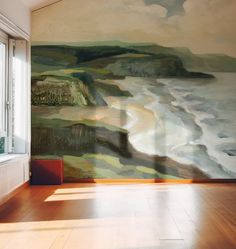 an empty room with a painting on the wall next to a window and wooden floor