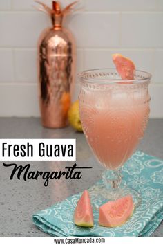 fresh guava margarita in a glass with slices of watermelon on the side