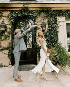 a man and woman standing in front of a door