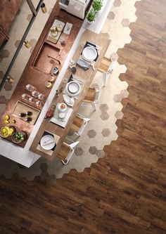 an overhead view of a kitchen and dining room with wood flooring on the walls