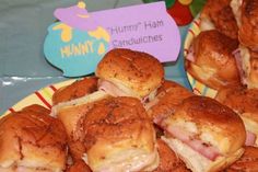 ham and cheese sliders sitting on a plate with a sign that says hummy ham sandwiches