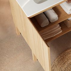 a bathroom sink with towels and toiletries in it