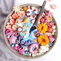 a bowl filled with lots of different types of candies and other things on top of it