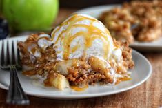 a plate topped with an ice cream sundae next to two green apple pies