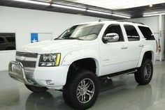 a white truck is parked in a garage