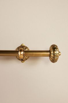 an antique brass door handle on a white wall