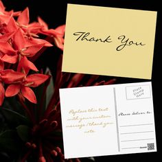 some red flowers are next to a yellow post - it note that says thank you