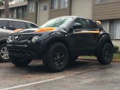 two cars parked next to each other in a parking lot