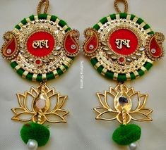 two green and red earrings with flowers on the bottom one has a gold plated earring