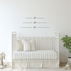 a white crib in a room with a wall decal that says, 22'x 30 '