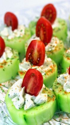 cucumber and tomato appetizers with sour cream on them are ready to be eaten