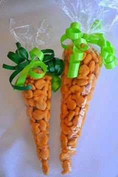 two carrots wrapped in plastic with green bows