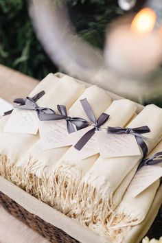 a gift wrapped in brown paper and tied with black ribbon on top of a table