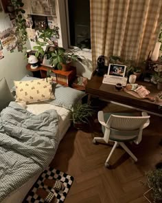 a small bedroom with a bed, desk and chair in front of a large window