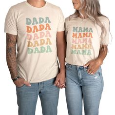 a man and woman standing next to each other wearing matching tshirts that say dada, mama, mamma