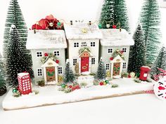 a white christmas village with trees and houses