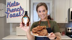 a woman holding a plate of food and a bottle of ketchup