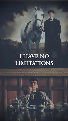 a man sitting at a table in front of a poster with the words i have no limits