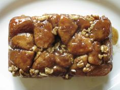 a close up of food on a plate with sauce and nuts in the middle,