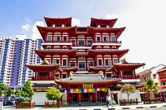 a tall red building sitting on the side of a road