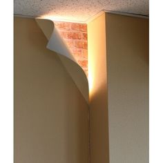 a light shines on the corner of a wall