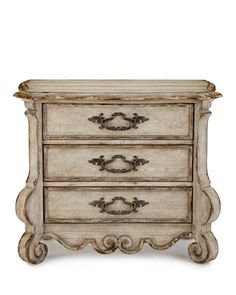 an old white dresser with ornate carvings on the top and bottom drawers, against a white background