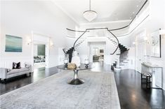 a large living room with white walls and black floors