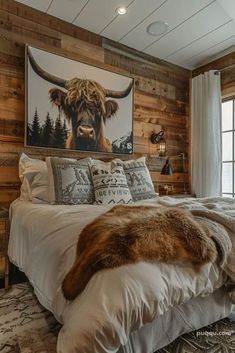 a bed room with a neatly made bed and a painting on the wall above it