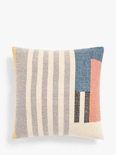 a striped pillow with an orange, blue and grey stripe pattern on it's side