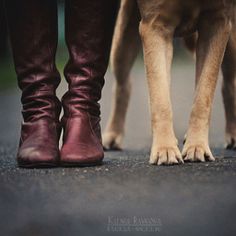 two dogs standing next to each other with their feet on top of the dog's leg