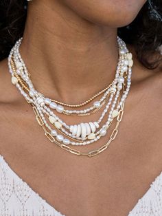 "Beautified with an assemblage of lustrous white freshwater pearl beads, this 18k gold filled pearl necklace alludes to the soothing sands of Hawaii's shores. Wear this gold pearl necklace alone or layered for a classically elegant look. ✦ DETAILS ✦ ✧ Name: Hiwahiwa (HEEvah HEEvah) - precious, beloved, indulged. ✧ Adjustable Length from: 16\"-18\" Inches. ✧ White 3-4mm Freshwater Pearls. ✧ 14kt Gold Filled Components, Extender, and Clasp. ✧ All Ke Aloha Jewelry pieces come packaged thoughtfully, White Multi-strand Pearl Chain Necklace, White Pearl Beaded Chain Jewelry, White Pearl Jewelry With Beaded Chain, White Multi-strand Pearl Charm Jewelry, White Multi-strand Jewelry With Pearl Charm, White Multi-strand Necklace With Pearl Pendant, White Pearl Jewelry With Gold Beads, White Multi-strand Beaded Necklace With Pearl Drop, White Multi-strand Pearl Drop Necklace