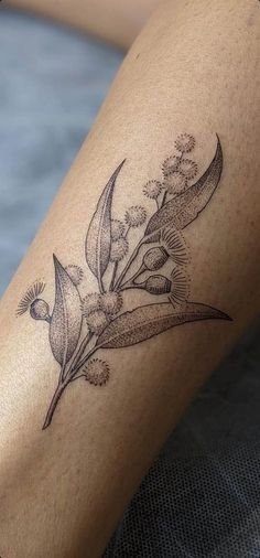 a close up of a person's leg with flowers on it